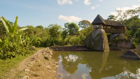 Indigenous construction over large sacred stones at the edge of a pond in Video stock 116207857
