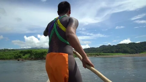 Indigenous Embera man operating his piragua boat up the river Video stock 77396736