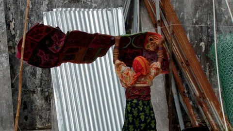 Indigenous Guna hangs molas blowing in wind on San Blas Stock Footage 98175480