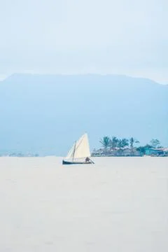 Indigenous Guna native Sailing in open sea with mountains and village Stock Photos