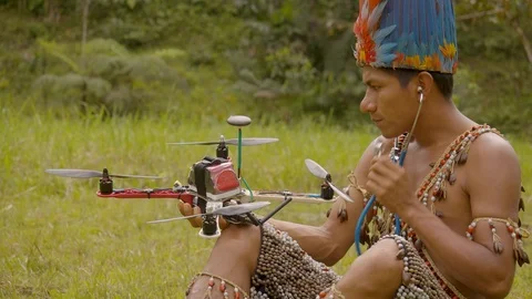 Indigenous man diagnostic a drone with a stethoscope in ecuador Stock Footage 113511234