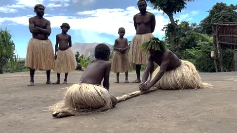 Indigenous Polynesian tribe making fire by rubbing stick to wood. Vanuatu Tanna Stock Footage 332155567