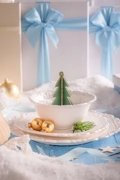 Indigo table layout featuring ornaments and snow. Stock Photos