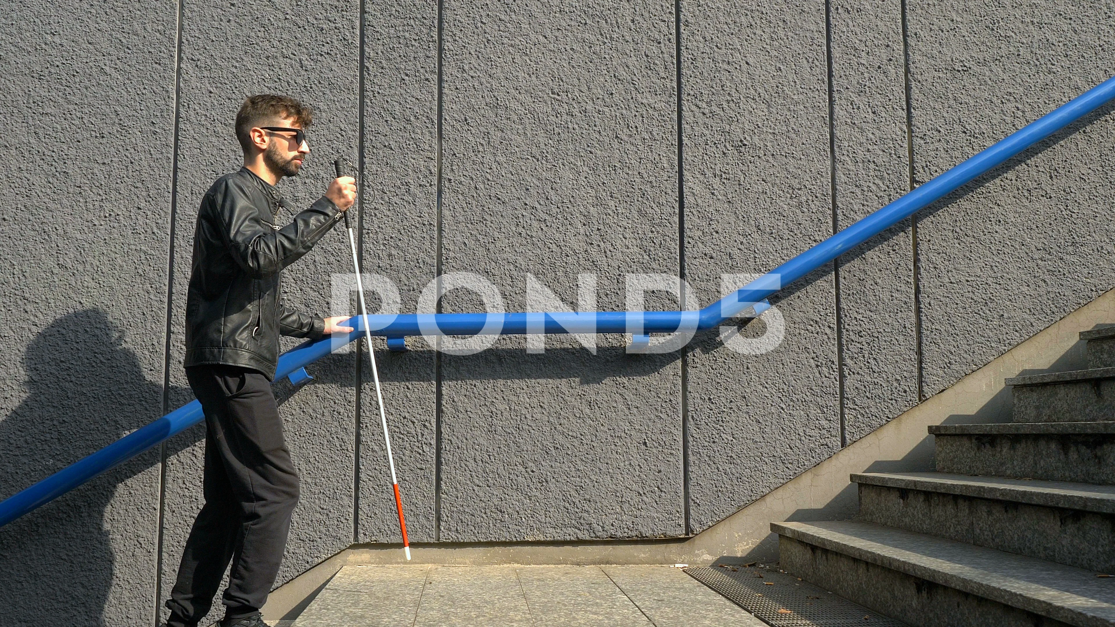 Blind man using his cane on the stairs - Stock Image - F012/4730
