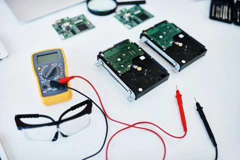 An indispensable tool in the world of IT. a multimeter testing the voltage of Stock Photos