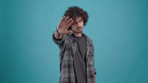 The indisposed man raises his hand to show the stop gesture twice. Stock Footage 149793697