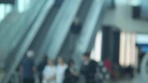 Indistinct travelers on escalators inside large transport hub Stock Footage 344654878