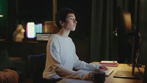 An Individual is Deeply Focused While Working Late at Night on Computer Stock-Footage 315001897