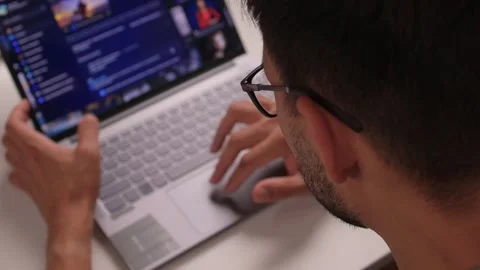 An Individual Deeply Focused on Working with a Laptop while Engaged in Stock Footage 315140374