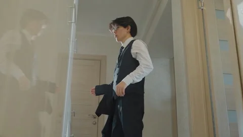Individual getting dressed carefully for significant job opportunity. Male Stock Footage 337234906