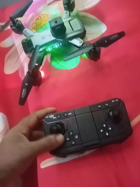 An individual grasping a remote control drone, ready to launch Stock Footage 310042948