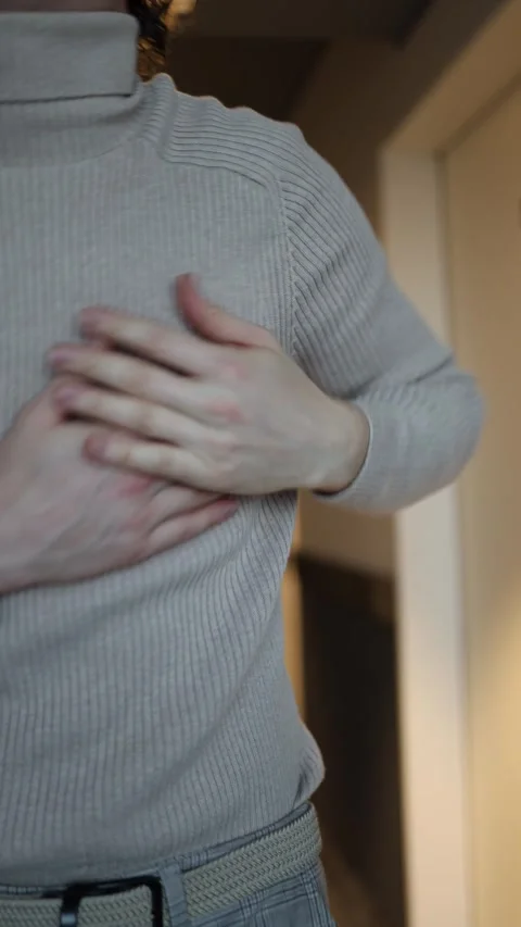 The individual in the image seems to be in discomfort, holding their hand to the Video stock 292514432