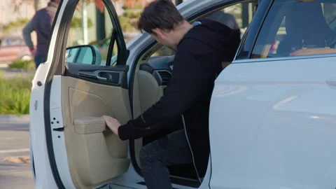 Individual interacting with a car door, preparing to access a vehicle Stock Footage 315532145