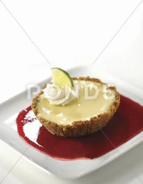Individual Key Lime Pie in a Berry Sauce Stock Photos