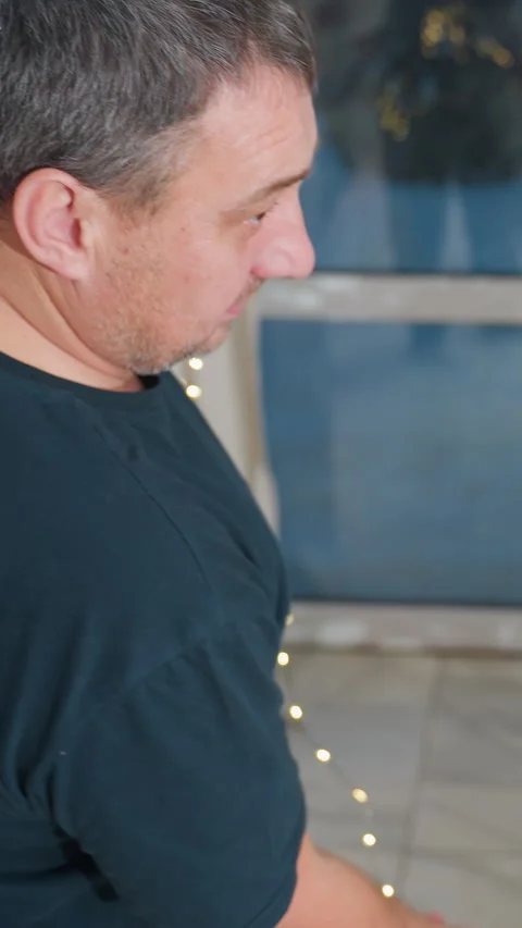 Individual organizing colorful string lights and garland indoors, Hobbyist Stock Footage 329520693