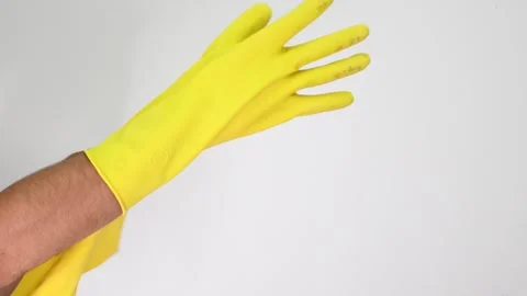 Individual Preparing to Clean with Yellow Rubber Gloves, Protection Against Stock Footage 305777410