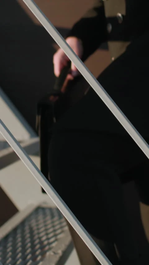 Individual Switching Briefcase from Left Hand to Right Hand While Climbing Stock Footage 310814147