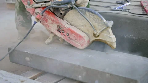 Individual using circular saw to cut concrete piece Stock Footage 270224556