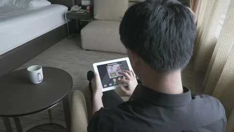 Individual Using Tablet in Modern Hotel Room Stock Footage 315116082