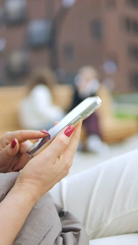 An individual is utilizing a smartphone while enjoying an outdoor environment or Stock Footage 286977747