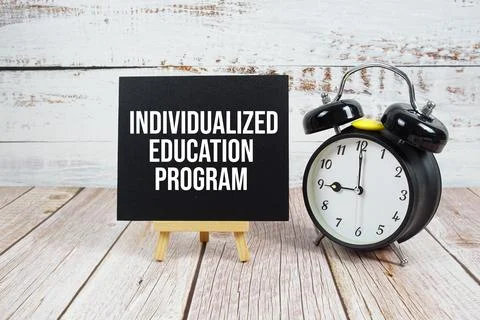 Individualized Education Program text with easel and alarm clock on wooden .. 写真素材