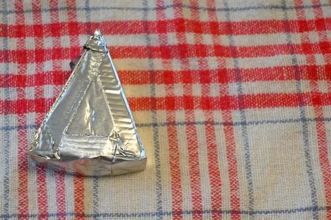 Individually wrapped processed cheese triangle Stock Photos