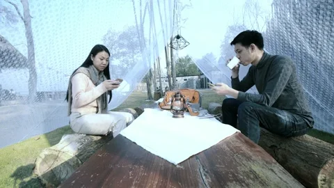 Individuals Engaged in Mobile Device Use in Outdoor Setting Stock Footage 313832389