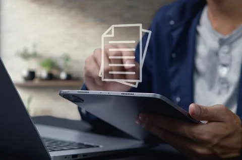 Individuals Transitioning to Digital Documents for Enhanced Efficiency 스톡 사진