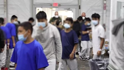 Individuals walking through temporary processing facility in Donna, Texas Stock Footage 151251761