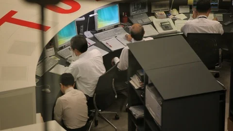 Individuals at workstations during a Calm Day at the Tokyo Stock Exchange Stock Footage 89364858