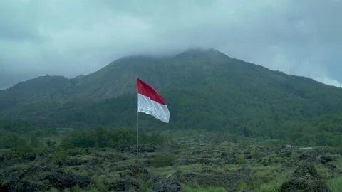 Indonesia Borlsha flag against the backdrop of Batur volcano in Bali Indonesia 動画素材 126972301