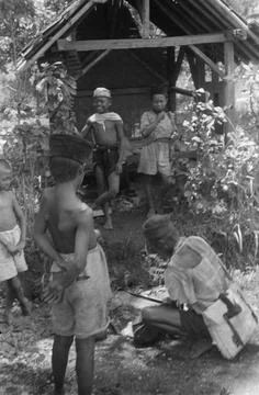 Indonesia. [DLC] Implementation of genie work. Group of young children looks at Stock Photos