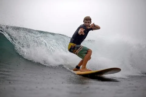 Indonesia, Java, man surfing and posing Photos