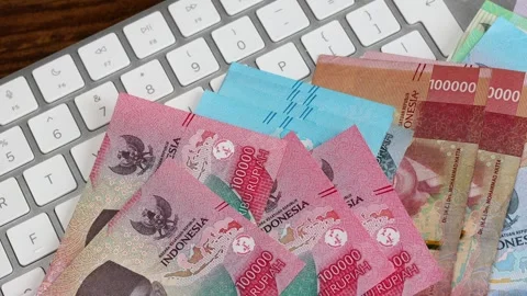 Indonesia money. White computer keyboard and cash counting. Large sum  Stock Footage 296892550