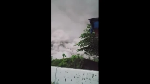 Indonesia: Volcano eruption ash cloud engulfs bridge as locals run to saf... Stock Footage 321401774