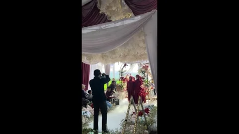 Indonesia: Wedding picture goes wrong when fog machine engulfs bridesmaid... Stock Footage 320631111