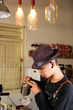 Indonesian Barista Prepare coffee drinks for customers at the coffee shop Stock Photos