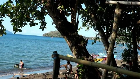Indonesian boy getting ready to swim with his rubber buoy Stock Footage 201031246