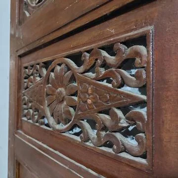 Indonesian Central Java ethnic wood carving which is commonly used for doors, wi Stock Photos