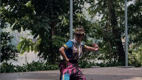 Indonesian Dancer Performing Elegant Scarf Dance Outdoors, Profile Stock Footage 237545273