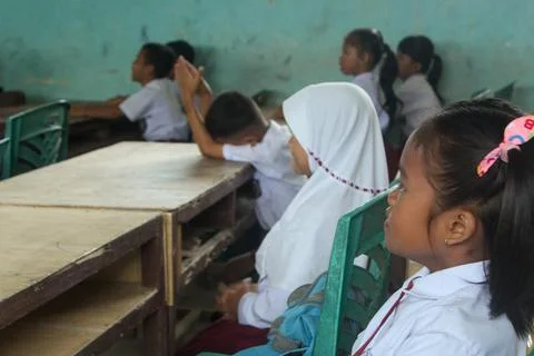 Indonesian elementary school students study in class. Stock Photos