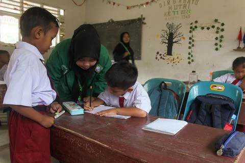 Indonesian elementary school students study in class. Stock Photos