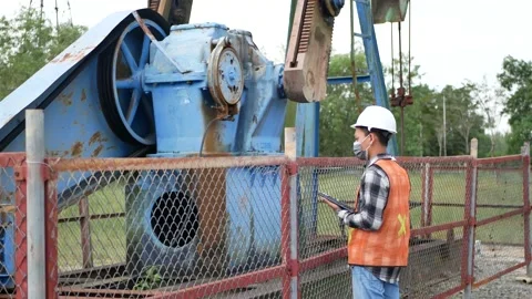An Indonesian engineer checking oil derrick field. 4K Video stock 150772874