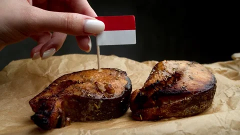 Indonesian flag on fish steak, symbol of local ocean catch in Indonesian cuisine Stock Footage 323013209