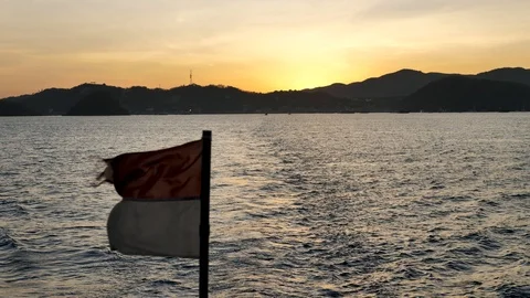 Indonesian Flag Flapping In Win With Beautiful Sunrise Background, Komodo Stock Footage 98771043