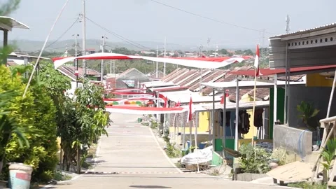 The Indonesian flag flies on the pole in front of the house Video stock 296553855