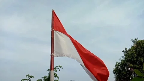The Indonesian flag fluttering under the evening sky. Stock Footage 325612754