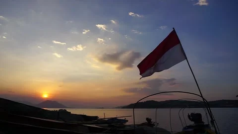 Indonesian flag on sunset sky Stock Footage 138773293