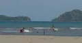 Indonesian kids playing at flat water beach with styrofoam boxes 4k or 4k+ Resolution