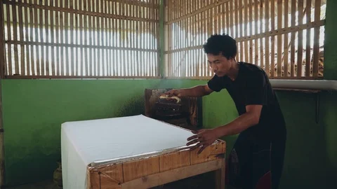 Indonesian man applying wax with cap to make batik Video stock 89031979